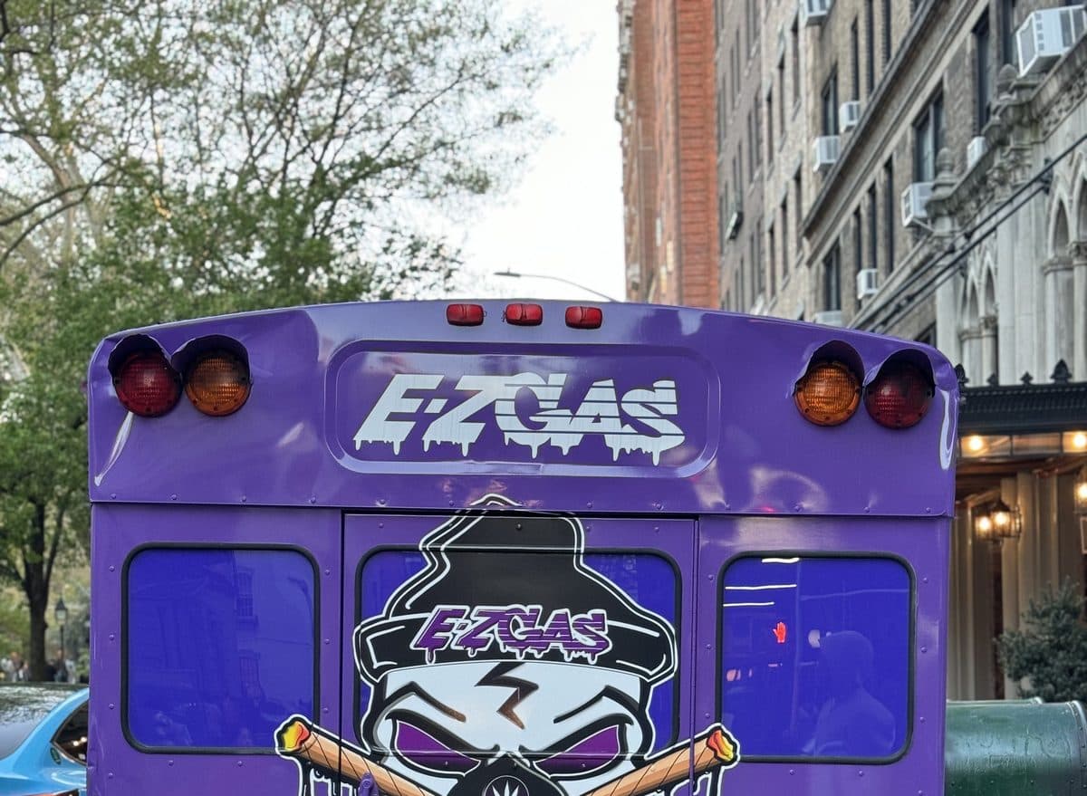EZ Gas bus rear on a NYC street — skull logo and candy purple wrap