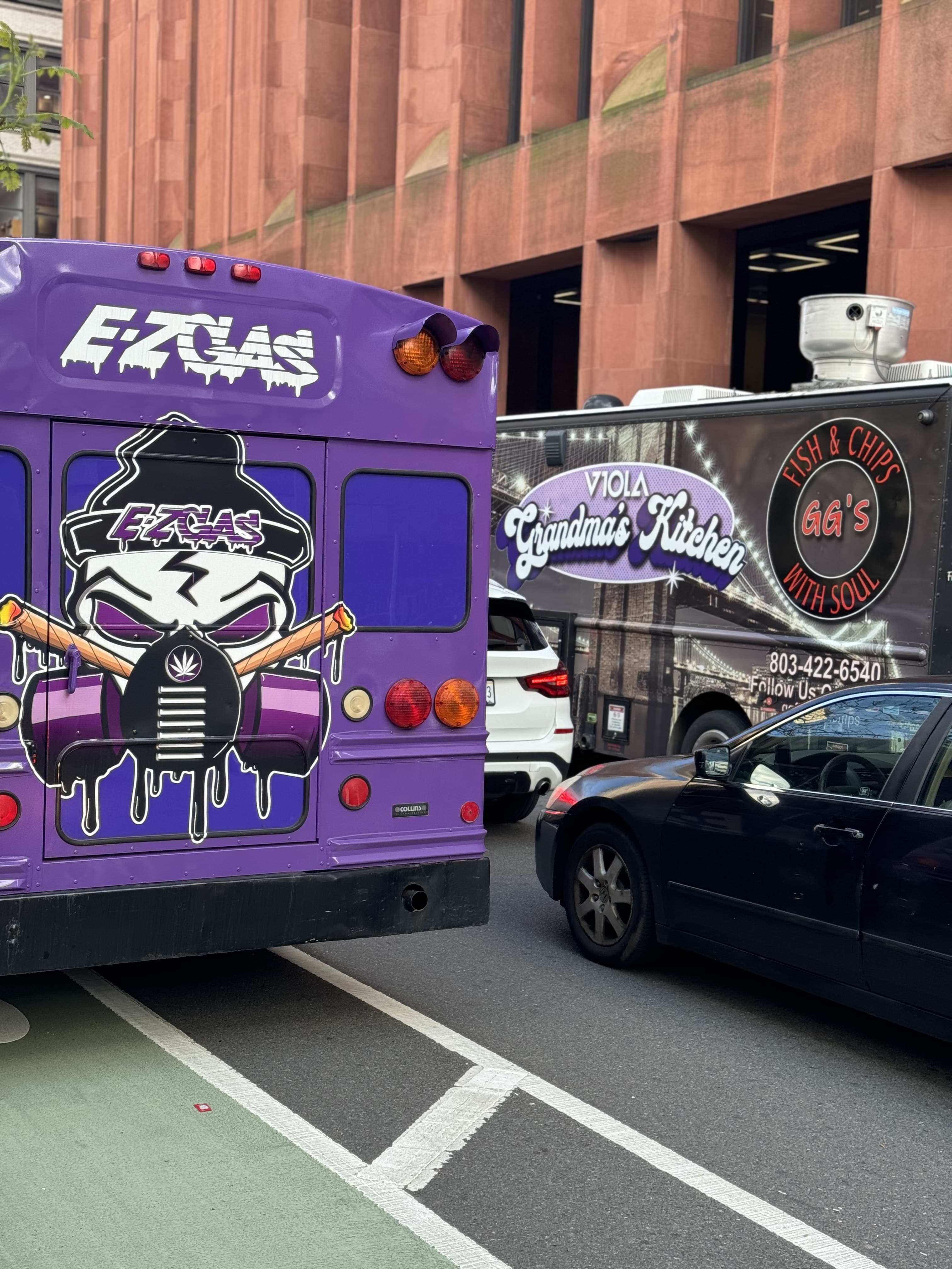 Bus rolling through the street, candy purple under streetlights